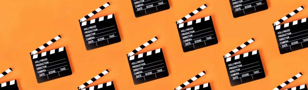 a row of clapper boards on an orange background .