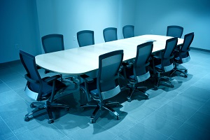 blue colored room with board room table and chairs