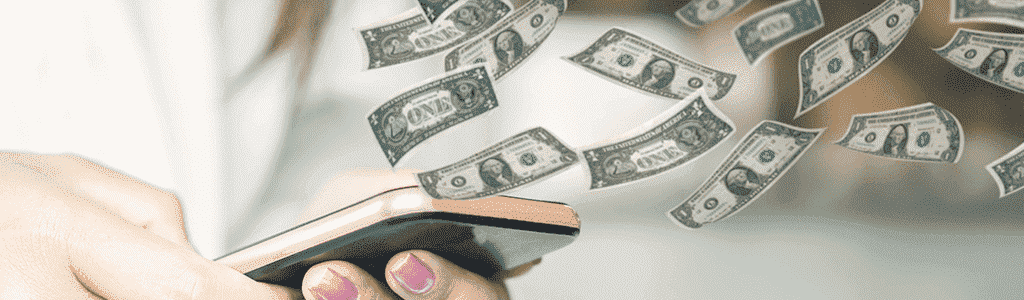 a woman is holding a cell phone with one dollar bills flying out of it
