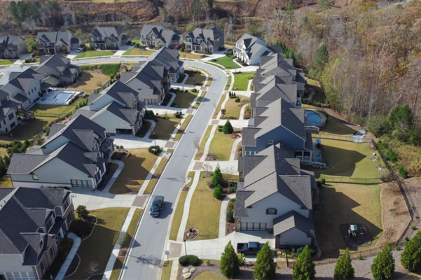 an aerial view of a residential neighborhood with lots of houses and home owners association
