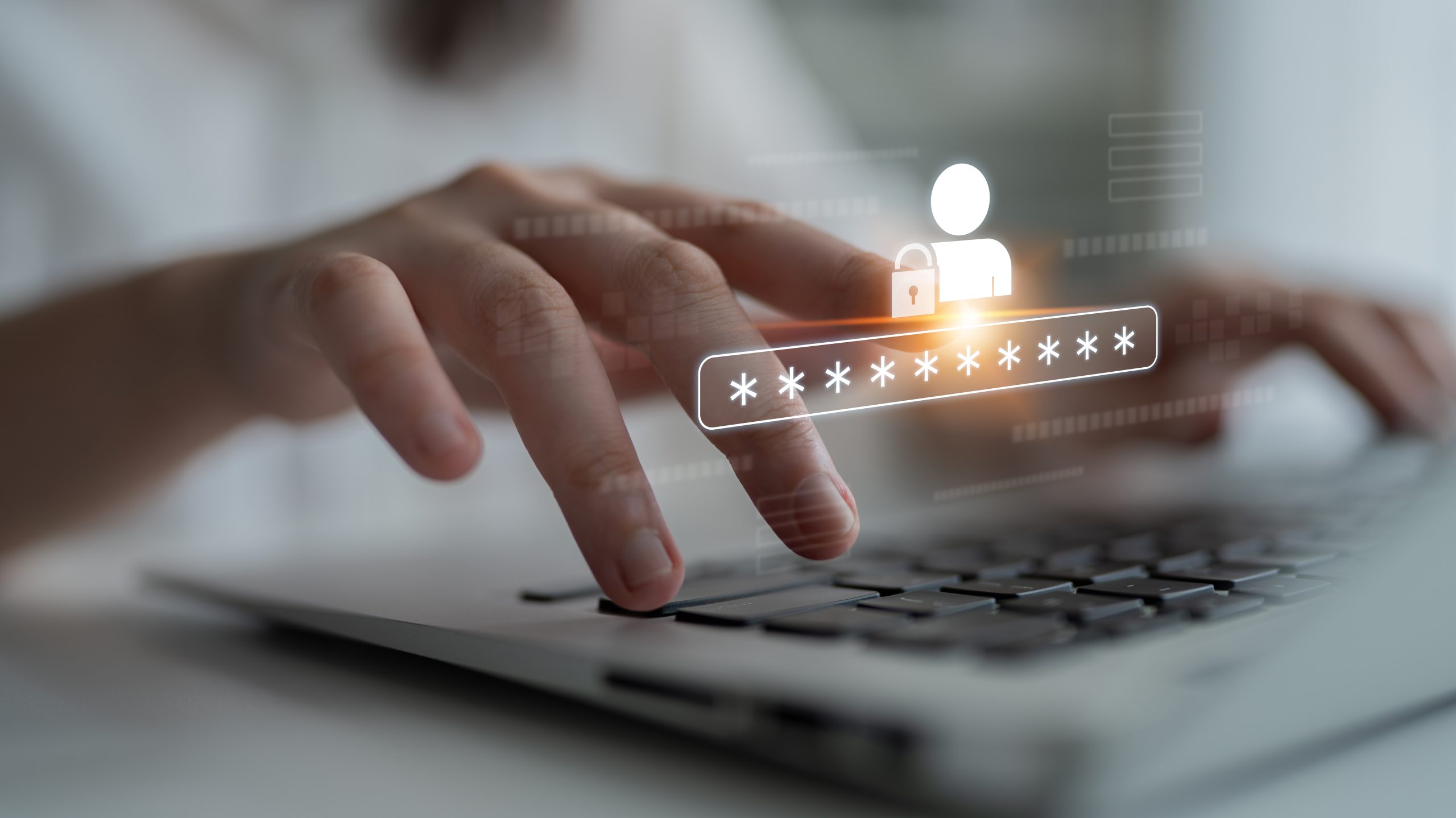 A person types on a laptop displaying a secure lock and star icons, indicating the use of secure login credentials.